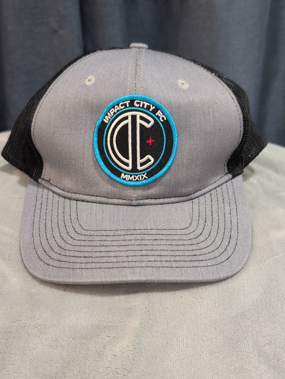 Port Authority Gray and Black Trucker Hat with Blue Patch